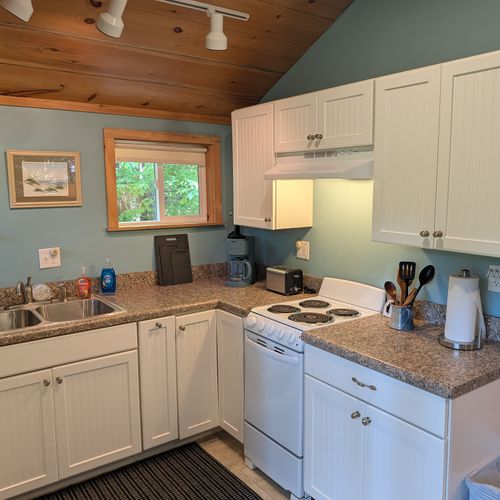 KITCHEN: The accommodating kitchen suited with a fridge, an oven, a toaster, a coffeemaker, and other kitchen essentials