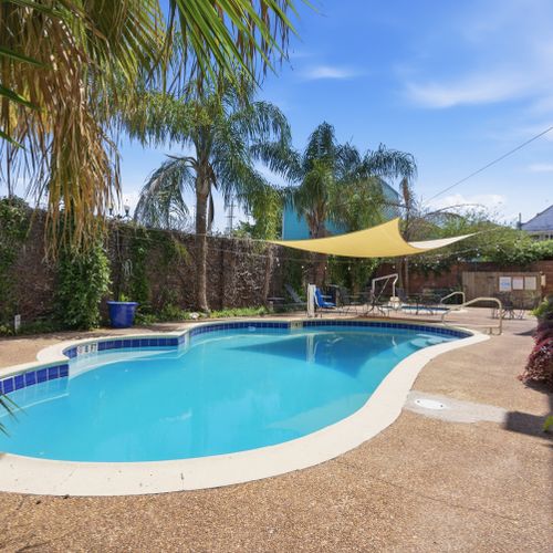Cool off in the sparkling pool surrounded by lush greenery & shade sails.