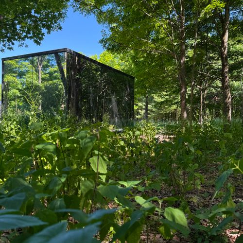 An architectural marvel: the stunning mirrored exterior completely blends into the peaceful Catskills forest.