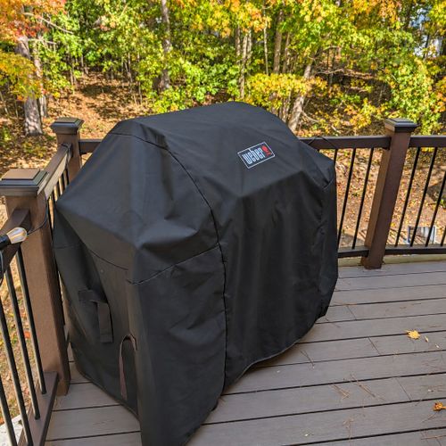 EXTERIOR:  Another photo of the backyard deck, highlighting the propane grill.