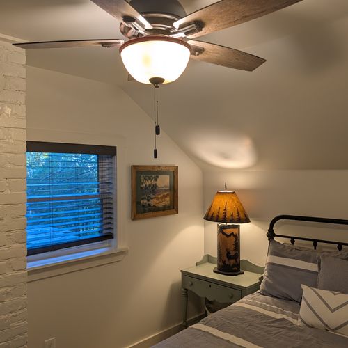 BEDROOM #2 (SECOND FLOOR):  Features a queen-size bed, nightstand, lamp, dresser, mirror, closet, and ceiling fan.
