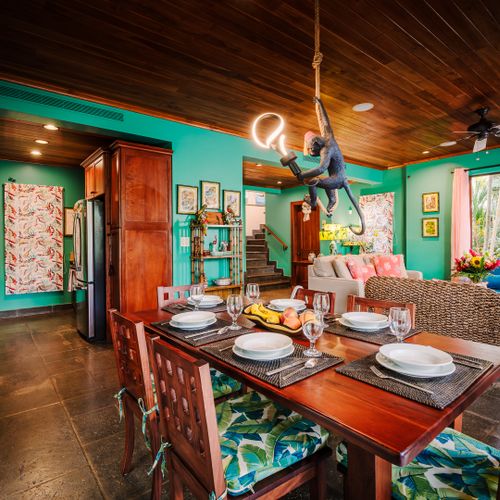 > Elegant dining table and stylish coastal decor at a luxury Playa Langosta vacation rental in Tamarindo, Costa Rica. Warm open space designed for family meals, entertaining, group stays, and comfortable beach house living near surf and beaches.