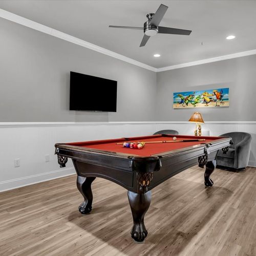 Game room with pool table, seating and smart tv