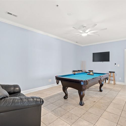 Oversized game room area with smart TV, pool table, and seating area