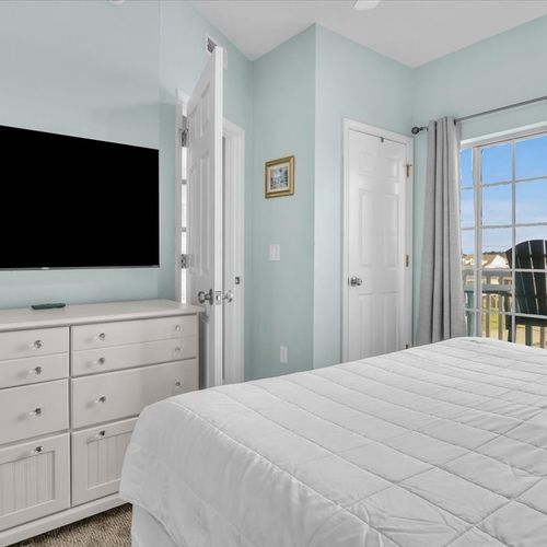 Bedroom with smart tv and balcony view