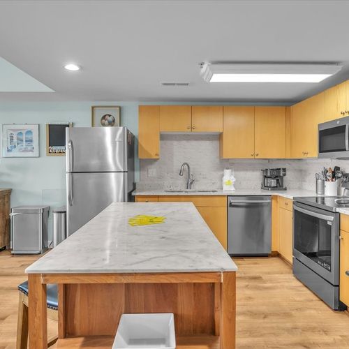 Kitchen with large island and 2 full size refrigerators