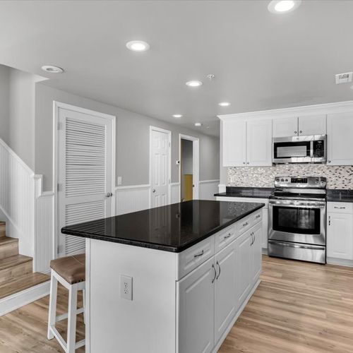 Kitchen with island and stairs to second floor