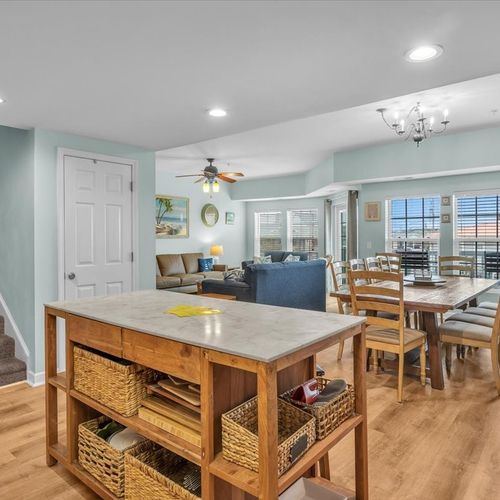 View from kitchen to dining area and living room with balcony view