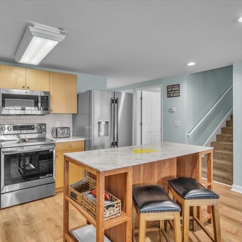 Kitchen view with view of steps to upper level
