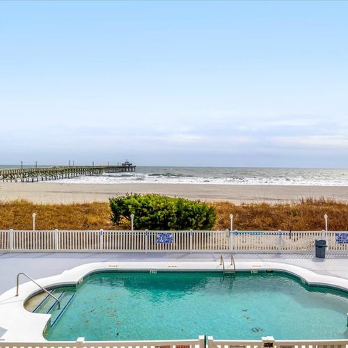 Pool is located oceanfront with view of Cherry Grove Pier