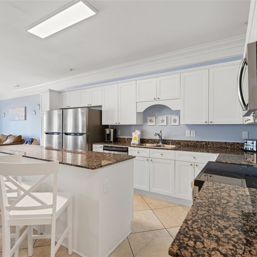 Kitchen with 2 full size refrigerators and island seating