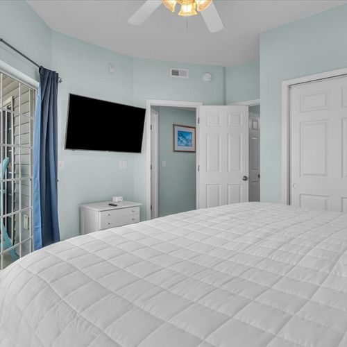 Bedroom with king bed and balcony view