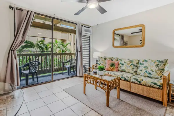 Bright living room with tropical décor and direct access to the lanai.