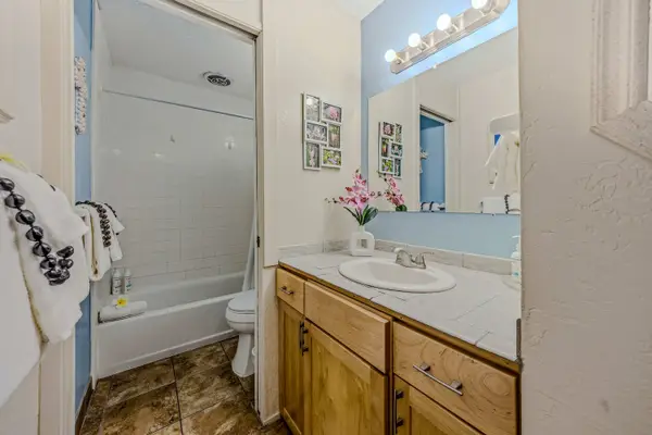 Full bathroom with a shower and spacious vanity.