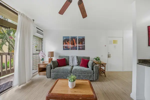 Cozy living room featuring comfortable seating, a wooden coffee table, and direct balcony access. 🛋️☀️