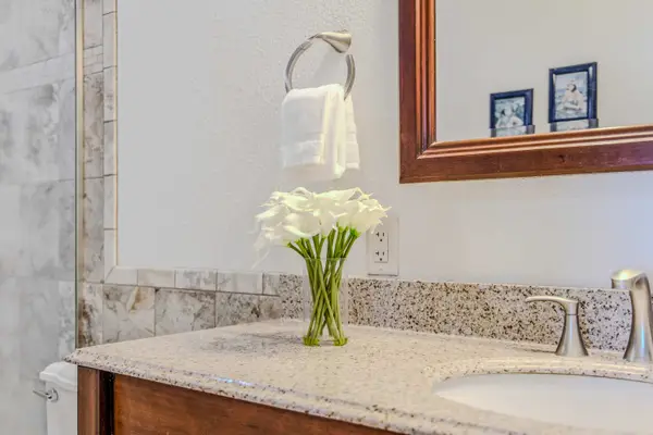 Bright bathroom vanity area featuring a spacious countertop and large framed mirror. 🪞
