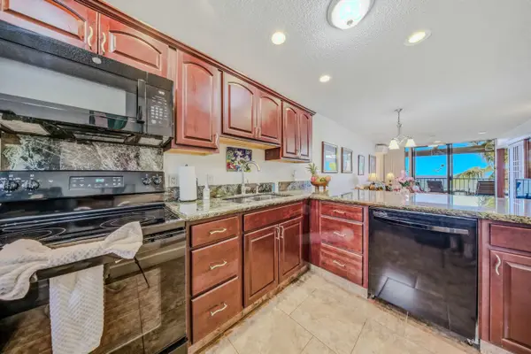 Spacious kitchen layout featuring wooden cabinetry, full appliances, and ample counter space. 🍳