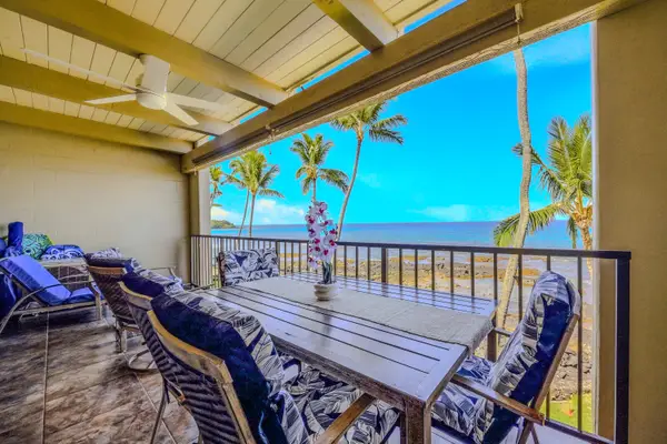 Spacious balcony dining table and chairs with an overhead fan and a beautiful ocean backdrop. 🍽️