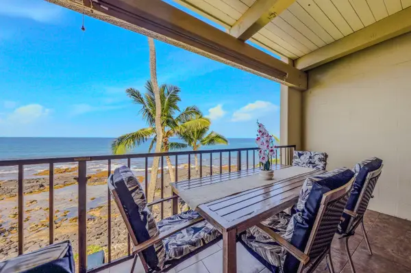 Charming balcony dining set featuring cushioned chairs and a beautiful ocean view. 🌊
