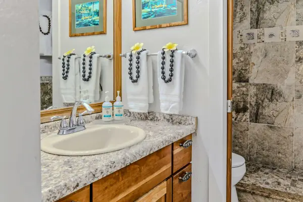 Fresh Towels And Island Accents In The Pristine Vanity
