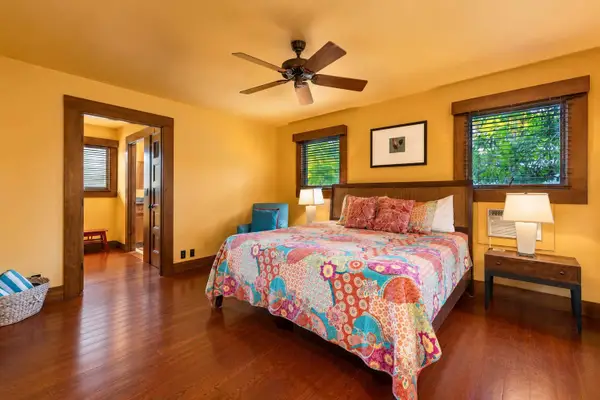 Wood-accented bedroom offers restful linens, bedside storage, and cheerful decor