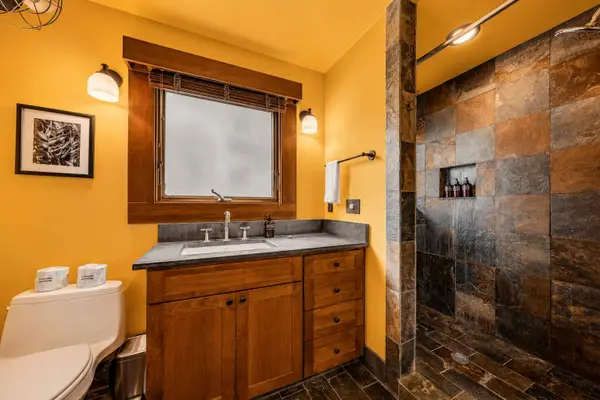 Contemporary bathroom combines colorful walls with practical storage and fittings