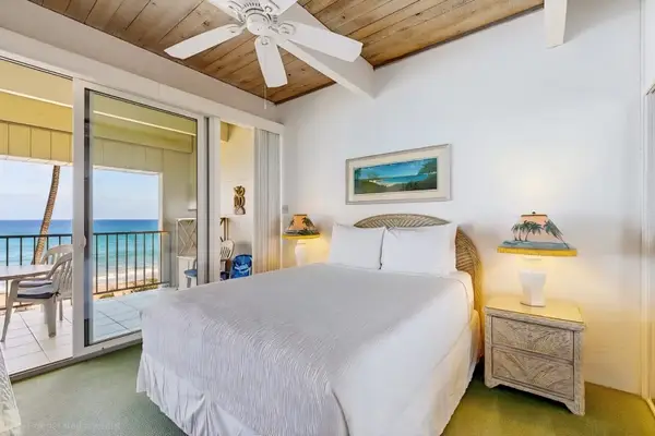 Bright Primary Bedroom with Vaulted Ceilings, Ocean Views, and Direct Balcony Access