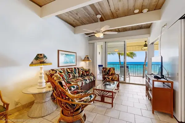 Bright Living Room with Vaulted Wood Ceilings, Comfortable Seating, and Ocean Views