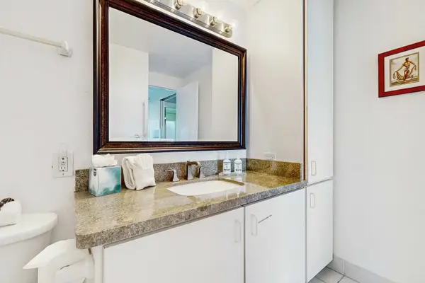 Bathroom Vanity with Counter Space, Large Mirror, Overhead Lighting, and Ample Cabinet Storage