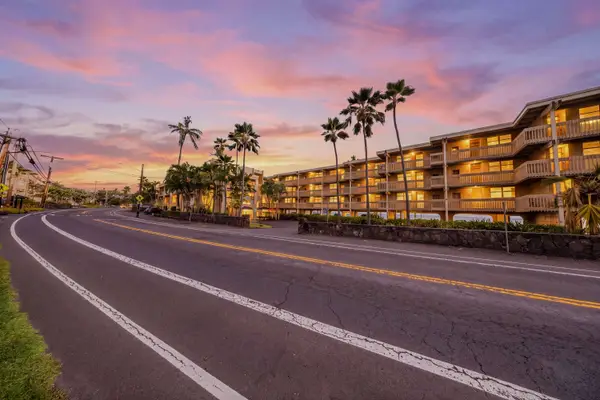 Resort Building Exterior and Roadway Illuminated Under Vivid Pink and Orange Sunset Skies