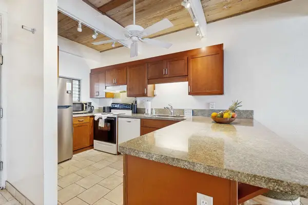 Fully Equipped Kitchen with Oven Range, Dishwasher, Refrigerator, and Double Sink