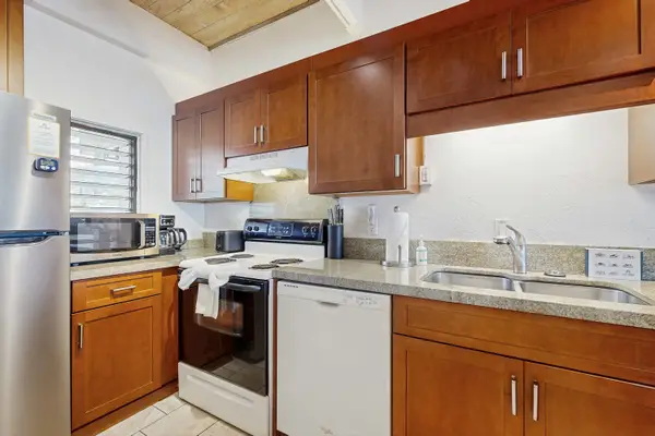 Fully Equipped Kitchen with Oven Range, Dishwasher, Refrigerator, and Double Sink