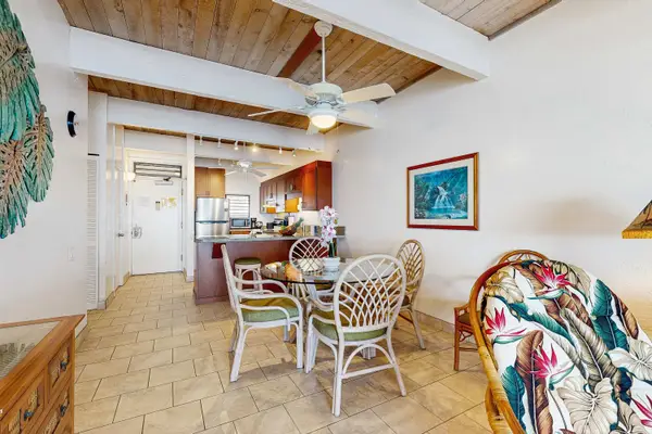​Dining Area with Table and Seating, Vaulted Ceilings, and Open View to Kitchen
