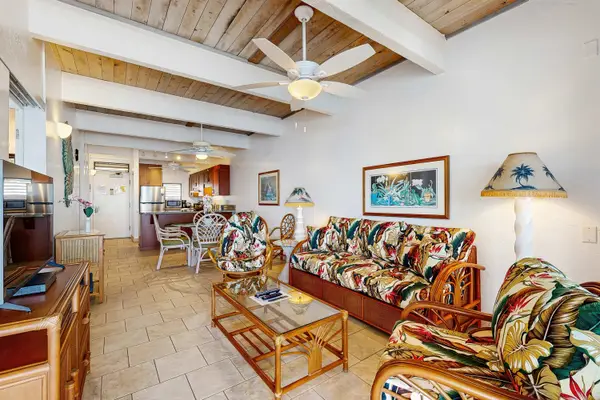 Open Living Room with Vaulted Ceilings, Wooden Beams, Ceiling Fan, and Ample Seating