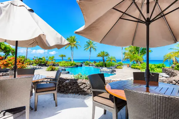Outdoor Dining Area with Umbrellas overlooking Ocean and Pool Views