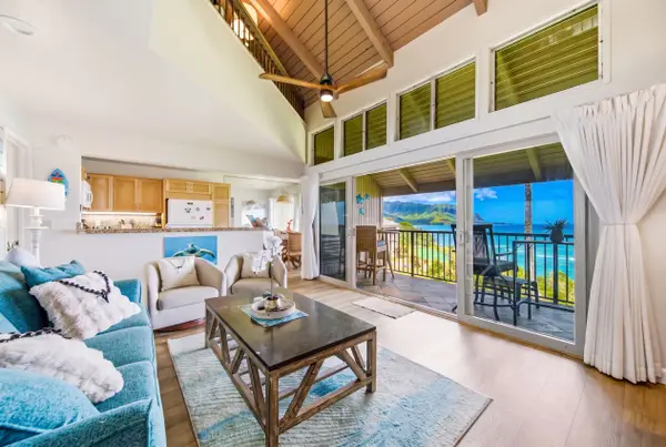 Open lounge presents stylish furnishings beside windows overlooking scenic island landscapes