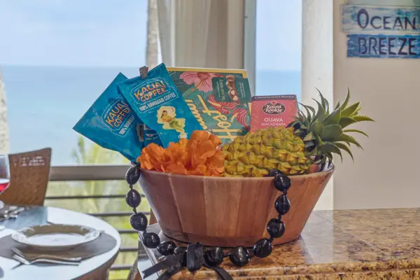 Welcome basket presents fruit, snacks, and ocean views for guests