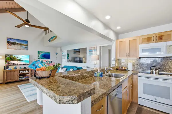 Modern kitchen showcases streamlined cabinets, stainless appliances, and organized counters