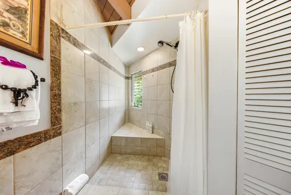 Modern bathroom features polished fixtures, bright mirrors, and contemporary tiling