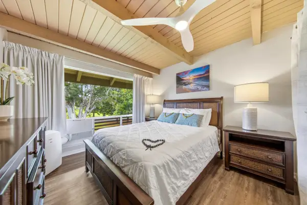 Sunlit sleeping space offers comfortable linens, tasteful decor, and tranquility
