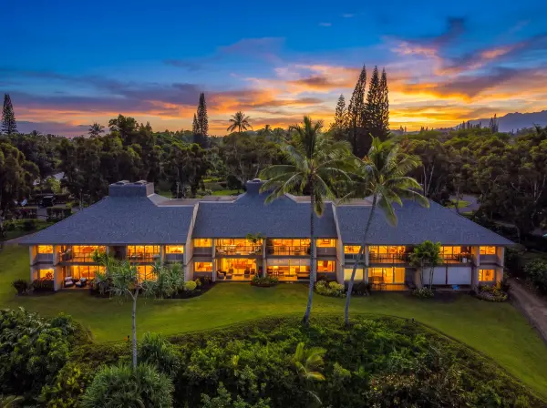 Well-presented property grounds feature colorful foliage and mountain outlooks nearby