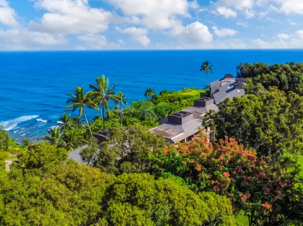 Island surroundings reveal lush gardens, rolling hills, and peaceful greenery