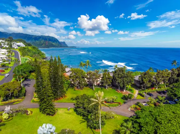 Surrounding landscape features tropical valleys, mountain ridges, and winding coastlines