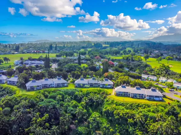 Expansive island views showcase lush terrain, blue skies, and greenery