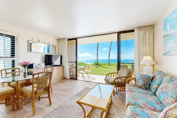 Living room with sleeper sofa and flat screen tv.  Views of the turquoise waters from comfort of your couch.