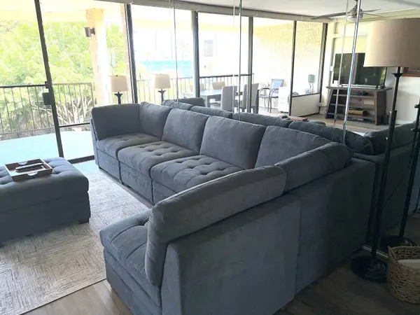 Spacious Sectional Seating Area Facing Floor-to-Ceiling Balcony Doors