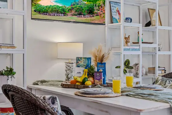 Dining table setup with breakfast fruit basket & orange juice
