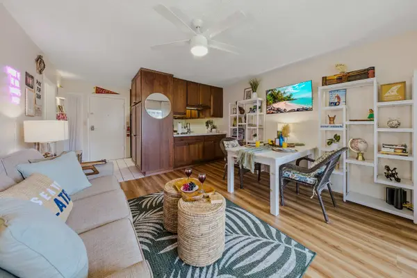 Open-Concept Living Area with Sofa, Dining Table & Kitchen