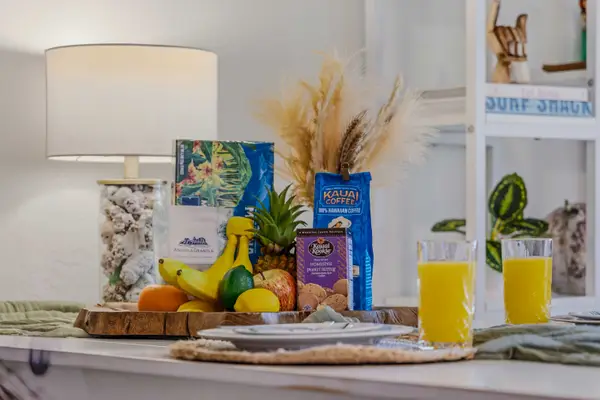 Dining table welcome spread with fresh fruit basket & juice glasses