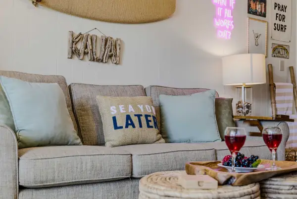 Cozy Sofa Lounge Setup with Wine Glasses & Island Décor